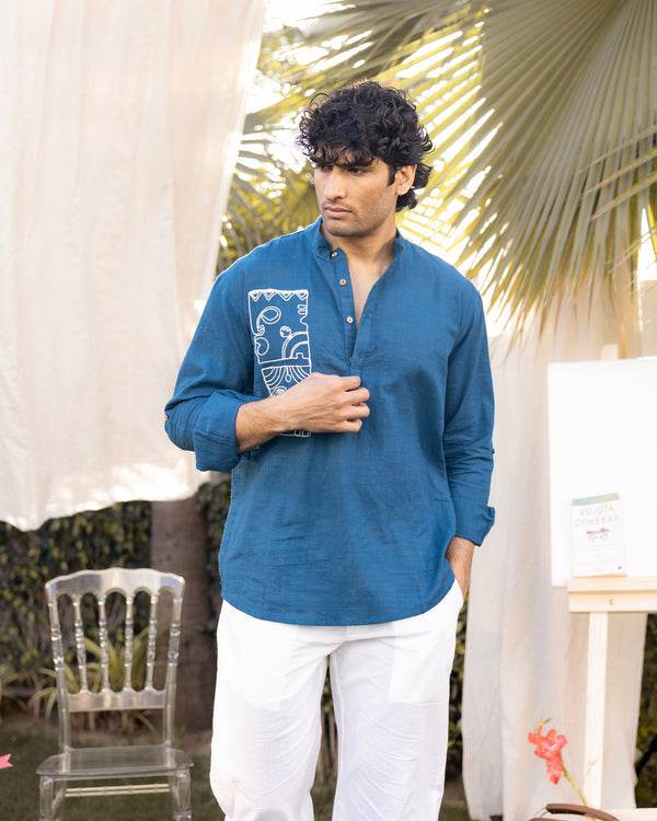 man wearing teal cotton slub embroidered short kurta with abstract motif and relaxed fit casual festive outfit