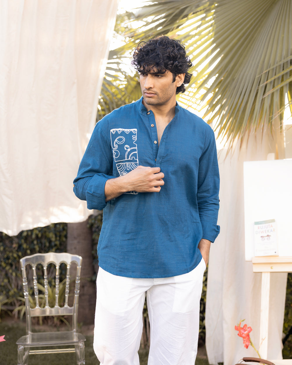 man wearing teal cotton slub embroidered short kurta with abstract motif and relaxed fit casual festive outfit