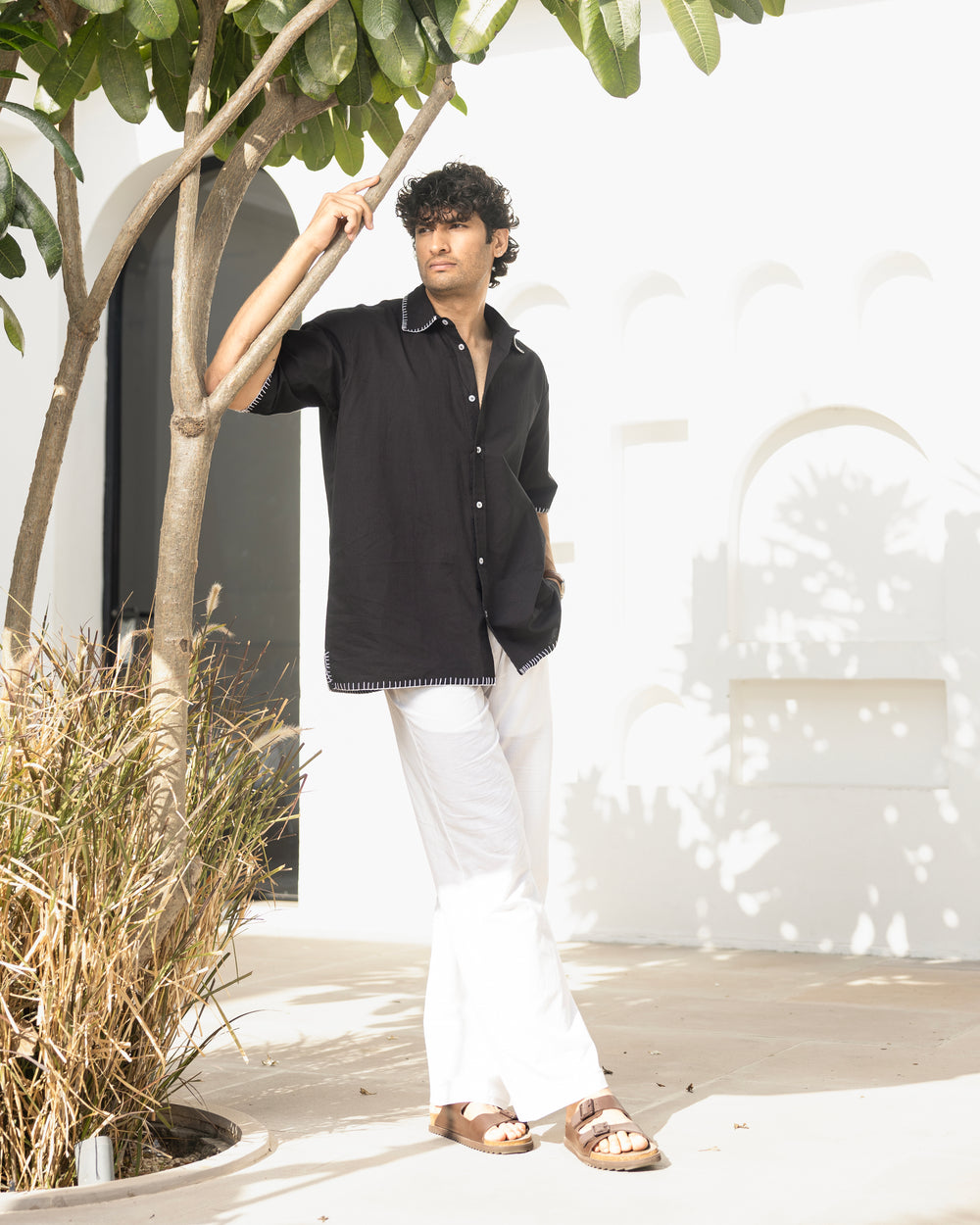 Minimal black cotton shirt for men featuring back embroidery and relaxed silhouette