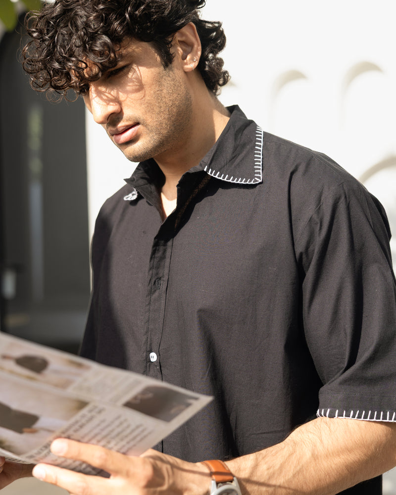 Stylish black Cuban collar shirt for men with white contrast stitching detail on collar and sleeves