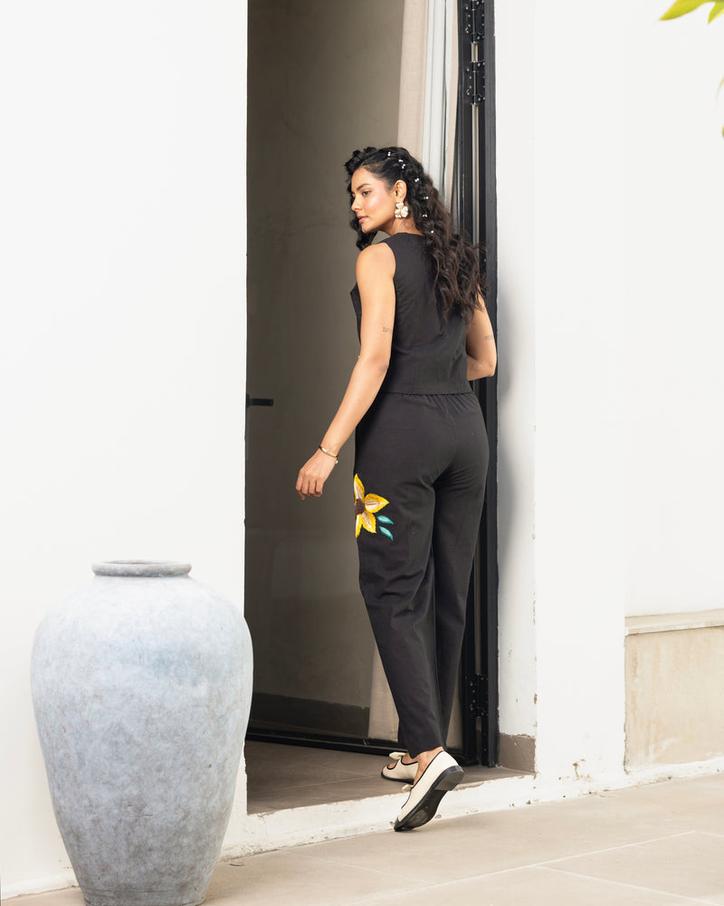 Detailed shot of black embroidered pants with yellow floral design in women’s co ord set