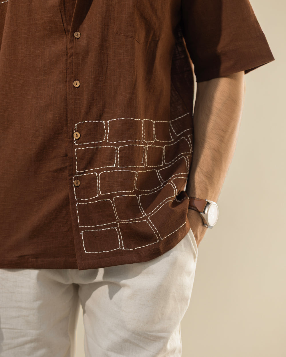 Brown shirt with geometric pattern on a neutral background