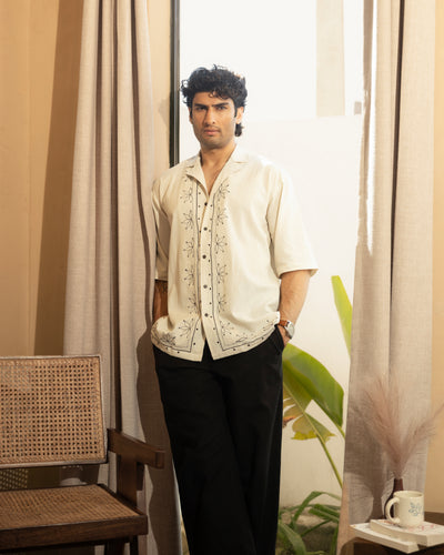 model wearing beige cuban collar cotton embroidered shirt relaxed fit summer resort outfit
