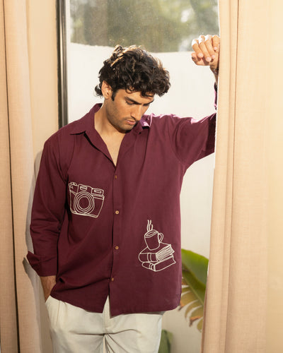 model wearing burgundy relaxed fit cotton embroidered shirt with camera and coffee line art design